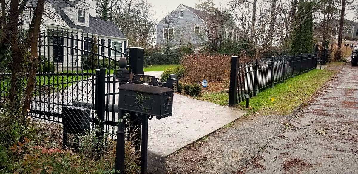 Black ornamental aluminum driveway gate and fence
