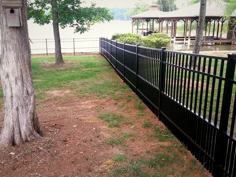 Black aluminum fence along a lakefront lot