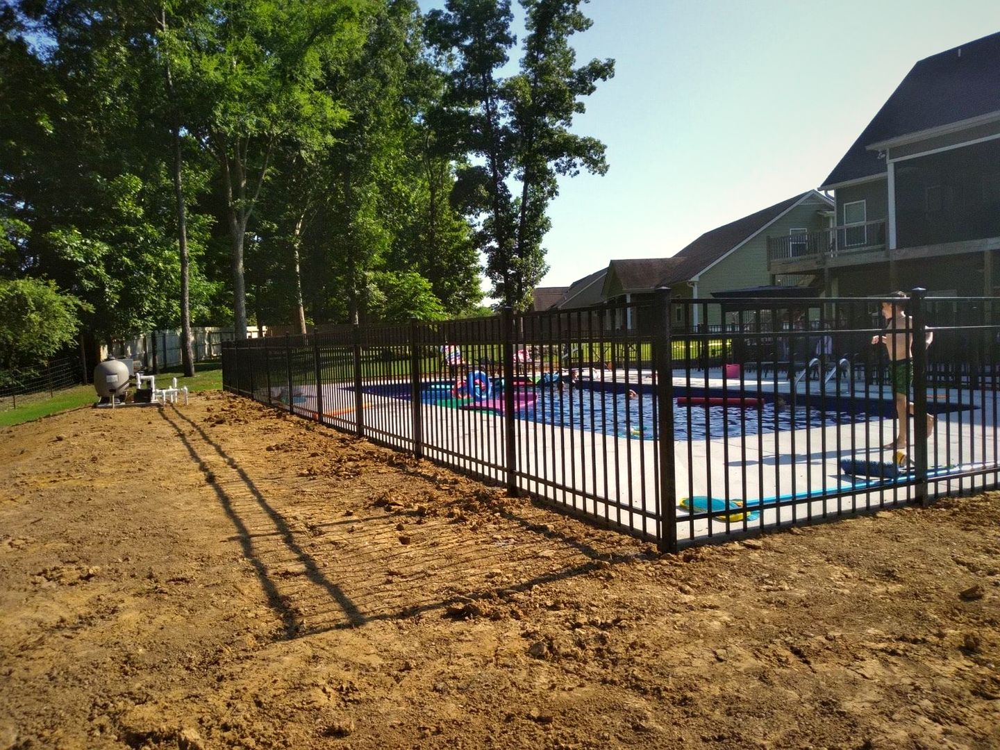Black aluminum fence around a neighborhood pool