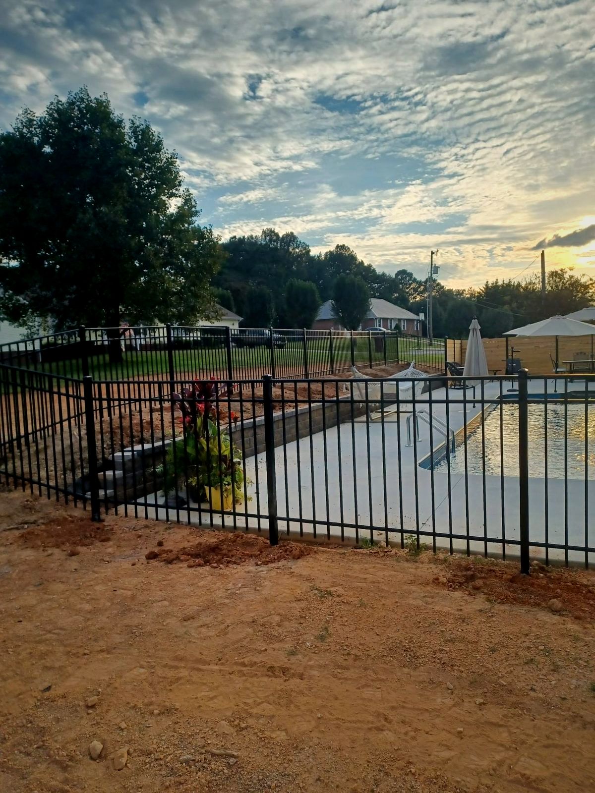 New black aluminum fence around an in-ground pool