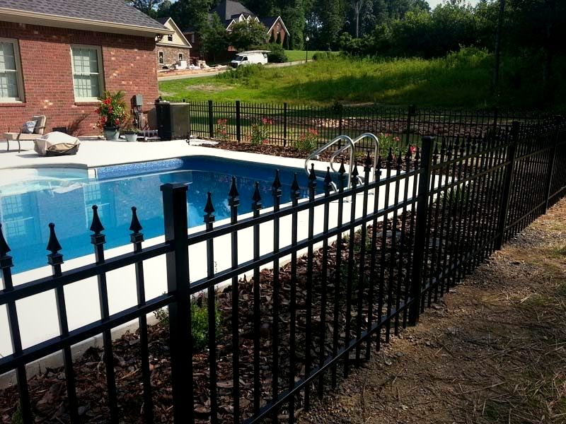 Spear-top black aluminum fence around a backyard pool