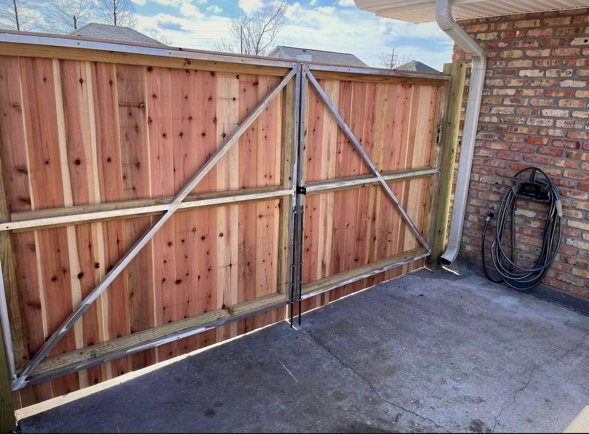 Cedar double gate built into a brick wall