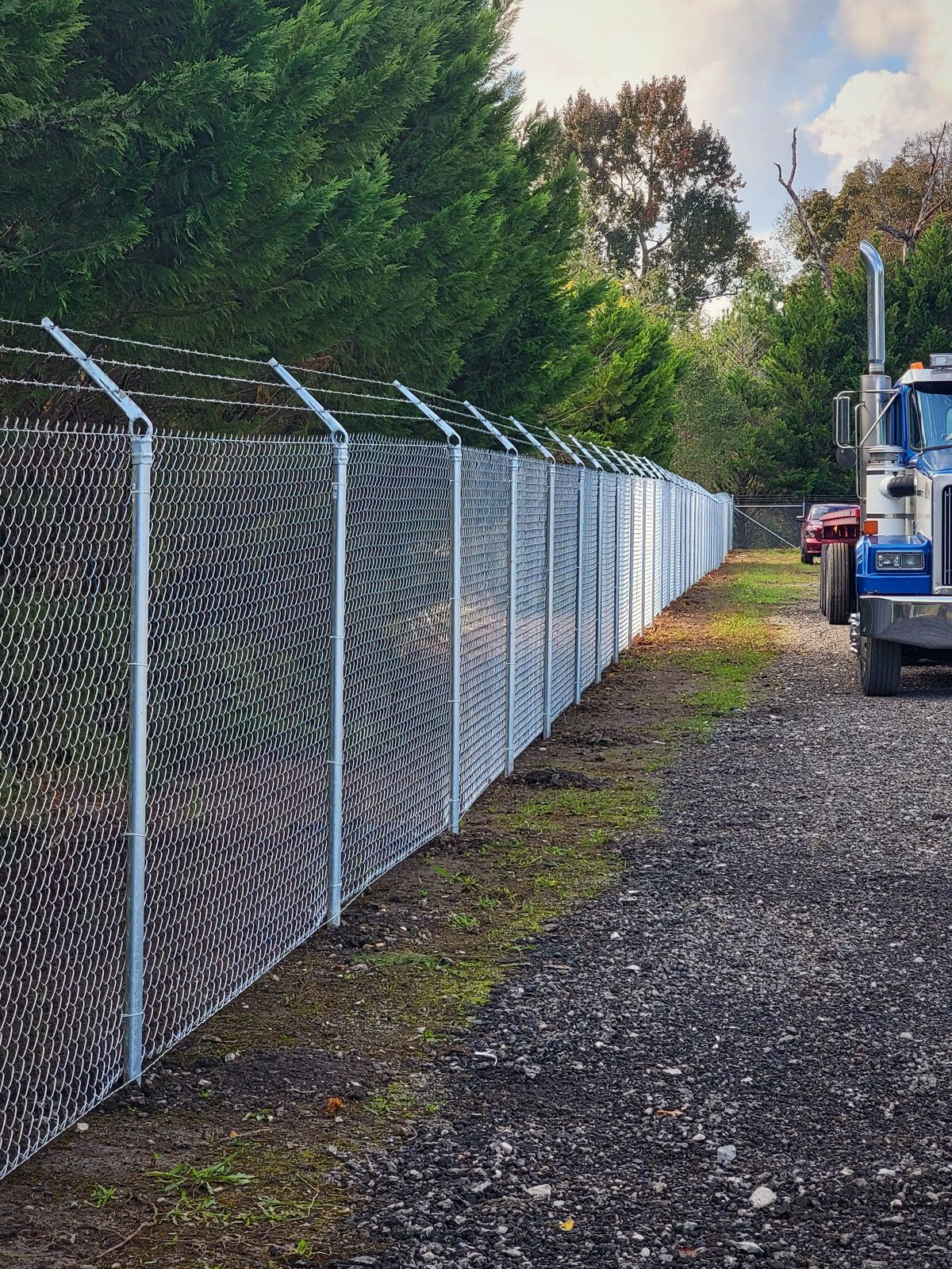 Galvanized chain link fence along a commercial driveway