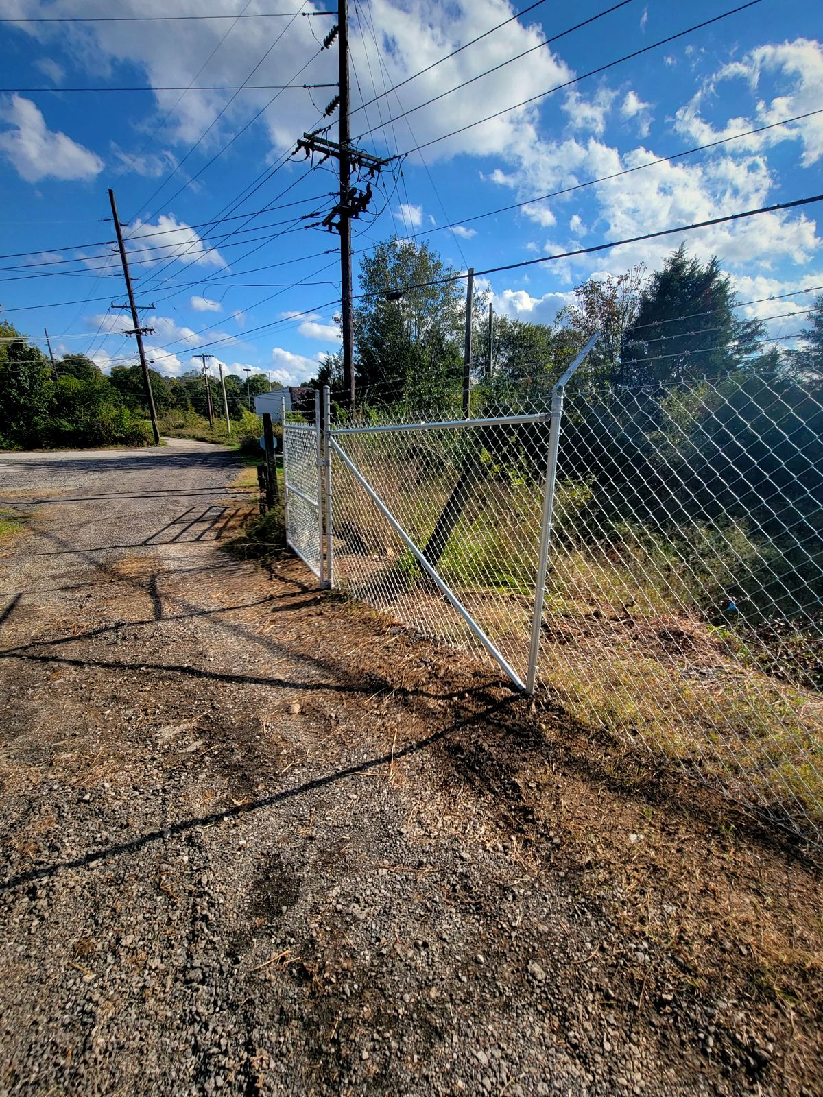 Galvanized chain link fence on a gravel lot