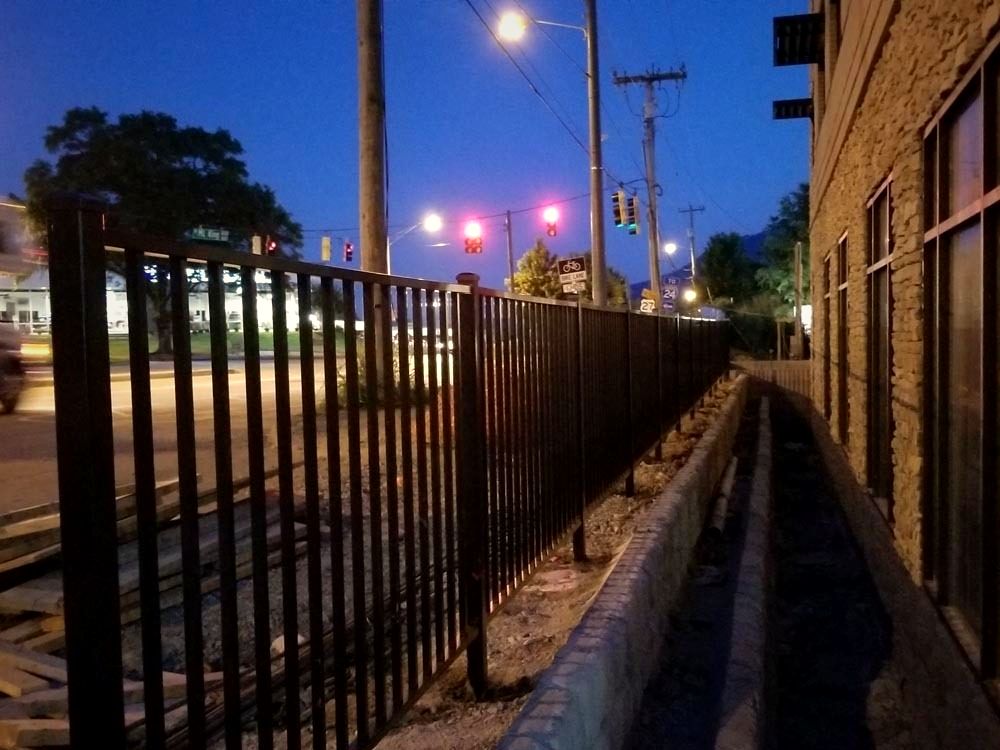 Black aluminum fence along Riverfront Parkway in Chattanooga at night