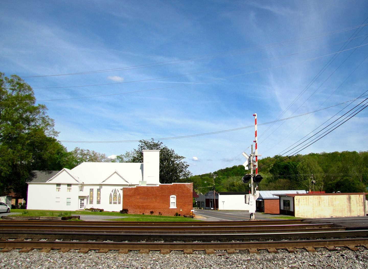 A white church and brick buildings along Wolfe Street and the railroad in Cohutta, Georgia
