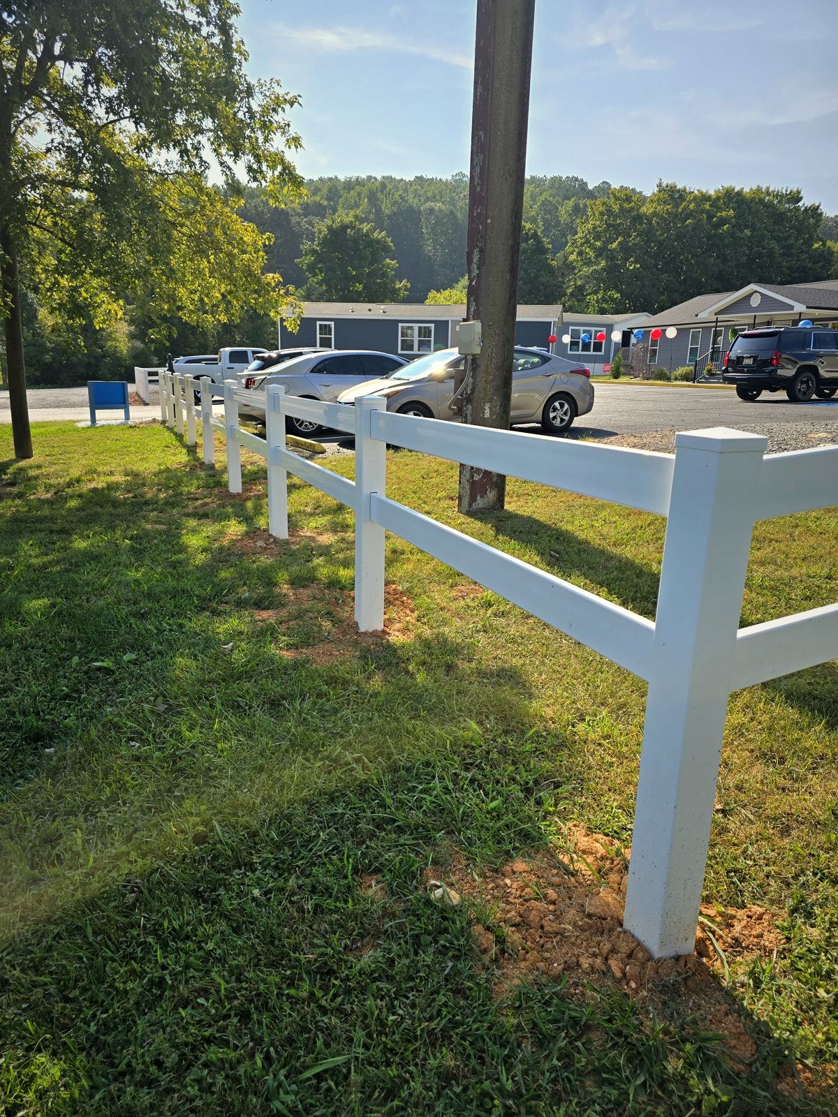 Vinyl Ranch Rail Along a Sidewalk