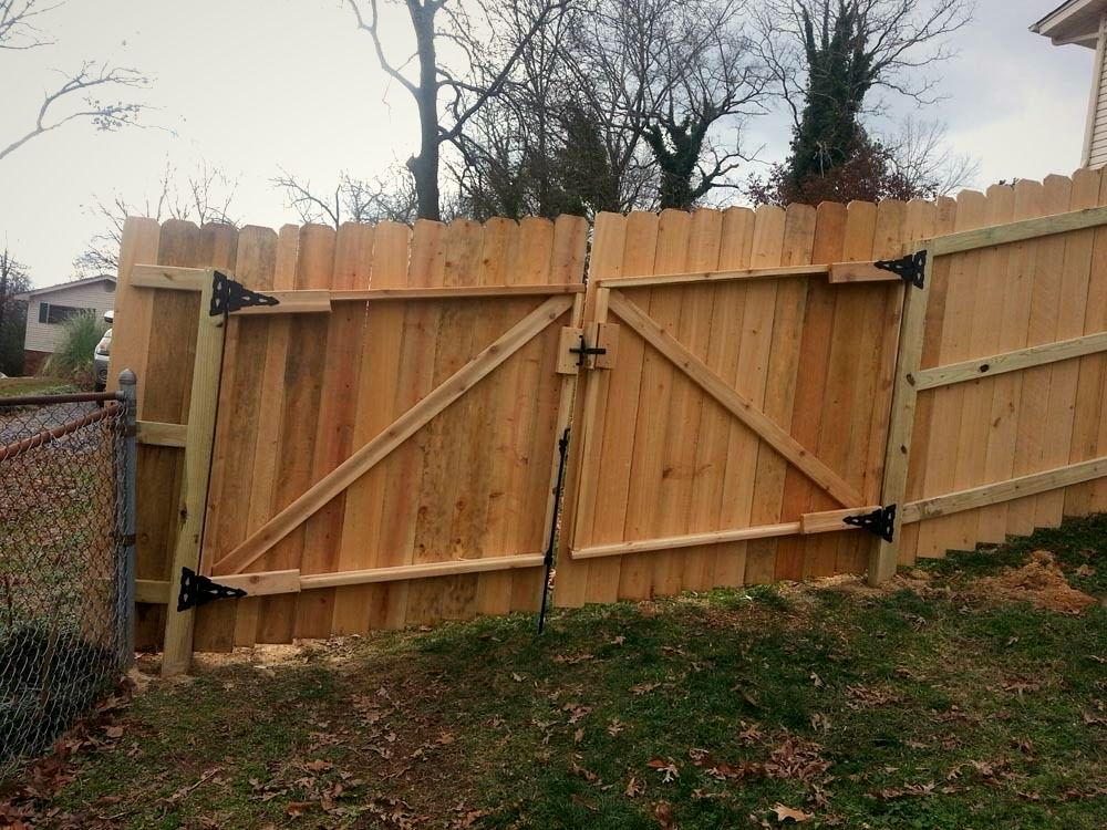 Wood privacy fence with a double drive gate
