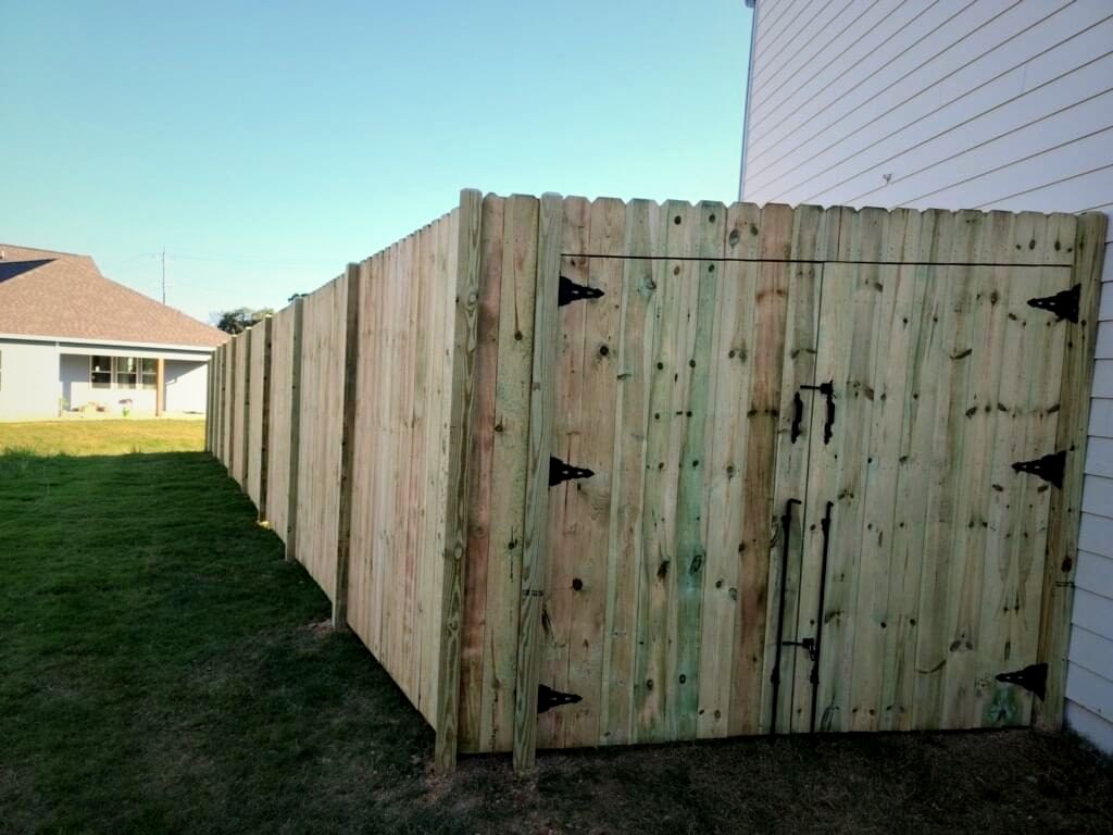 Wood privacy fence with a walk gate