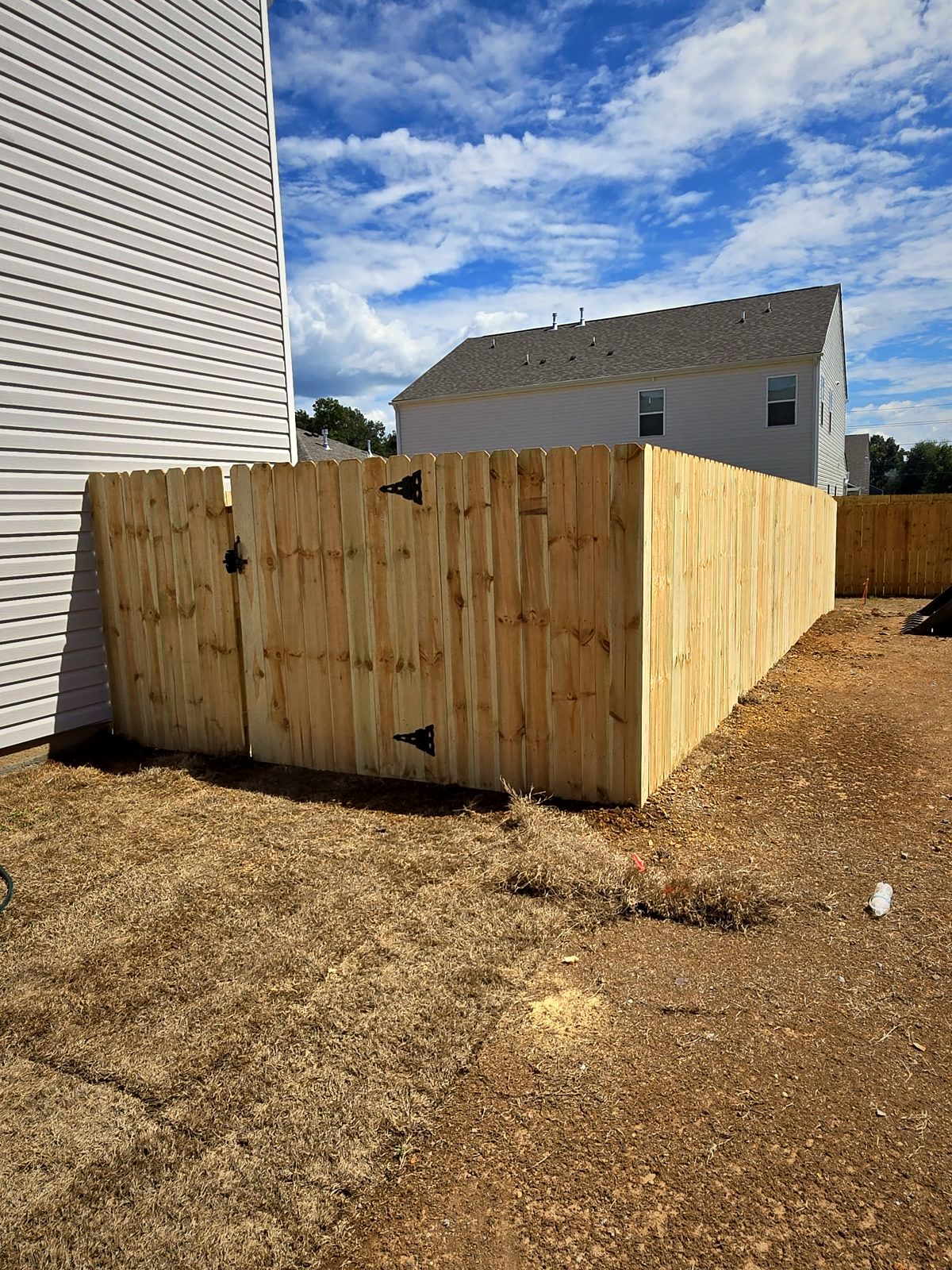 New wood privacy fence around a new-construction backyard