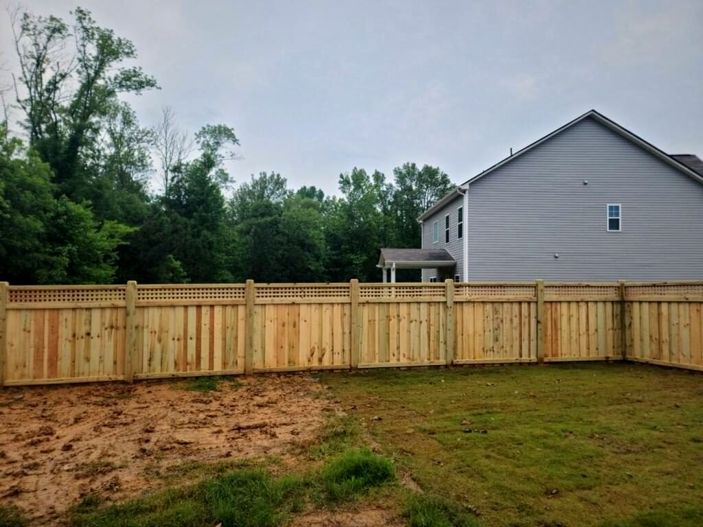 Wood privacy fence around a new subdivision backyard