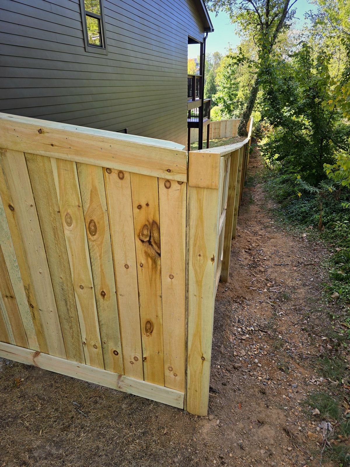 Wood privacy fence turning the corner of a house