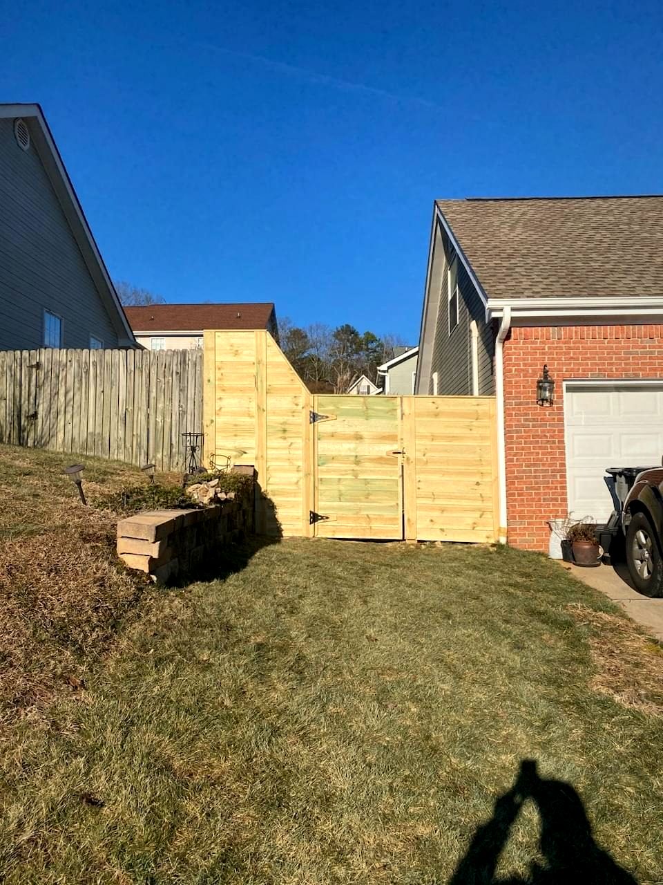 Wood privacy fence with a gate between two homes