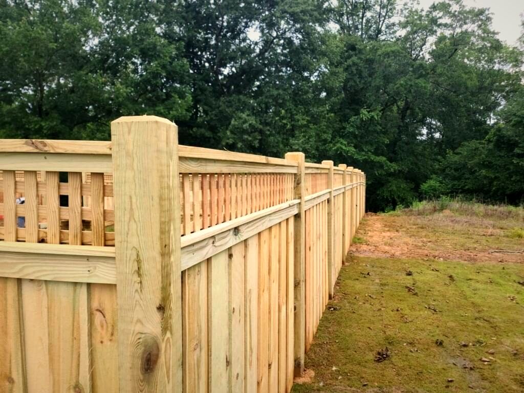 Wood shadowbox fence with a decorative top rail